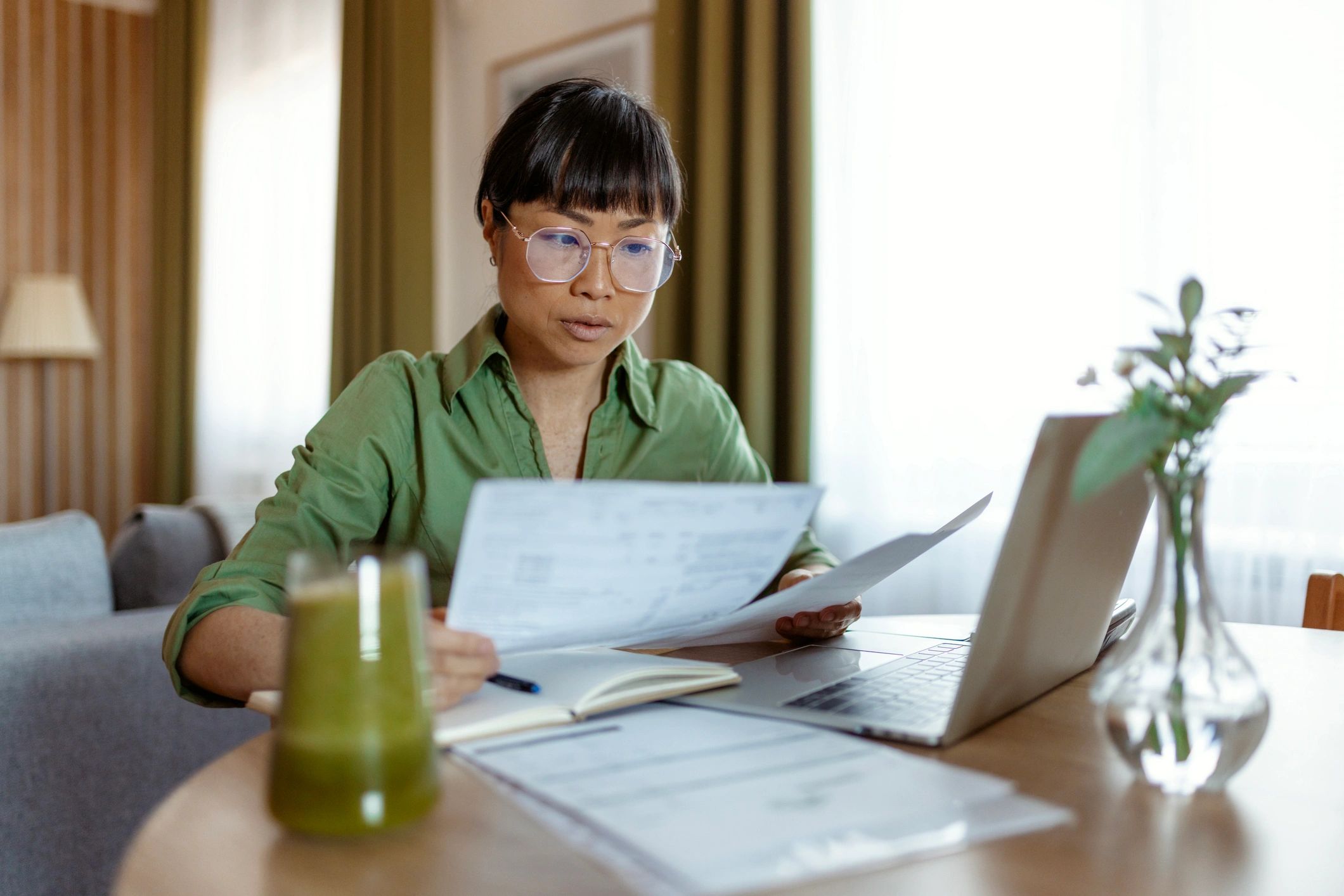 Homeowner reviewing finances at a desk to plan next steps